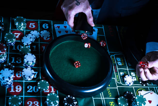 istock Casino background, poker Chips on gaming table, roulette wheel in motion, 1186140282