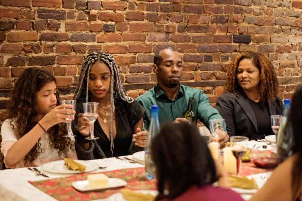 istock Family cheering enjoying Thanksgiving dinner. 1186140335