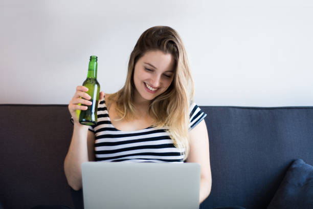 istock Young woman using a laptop computer at home 1186140412