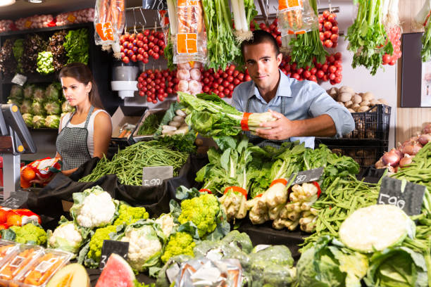 istock Two positive sellers working behind the counter 1186141021