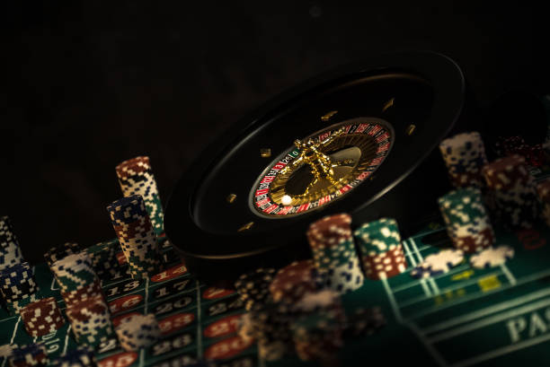 istock Casino background, poker Chips on gaming table, roulette wheel in motion, 1186141653