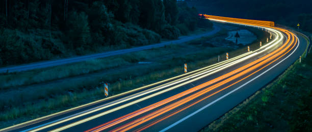 istock lights of cars with night 1186143021