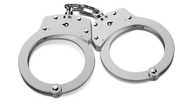 istock A chrome handcuffs with the shadow isolated on white background. 3d rendering illustration. 1186143312