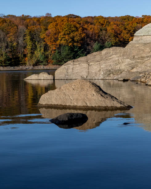 istock autumn lake reflections with rocks and reflections 1186144081
