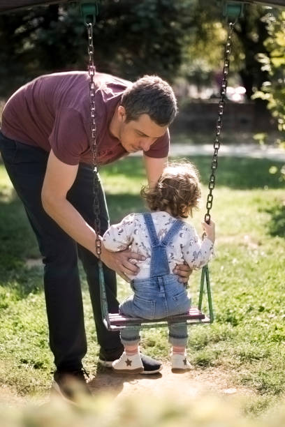 istock Father and daughter in park 1186144656
