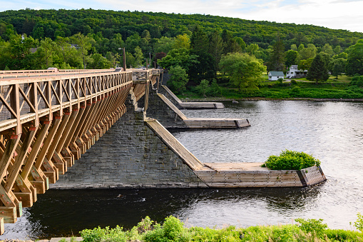 This is a photograph of the historic Roebling Bridge (Roebling’s Delaware Aqueduct)spanning the Delaware River between New York and Pennsylvania in spring.