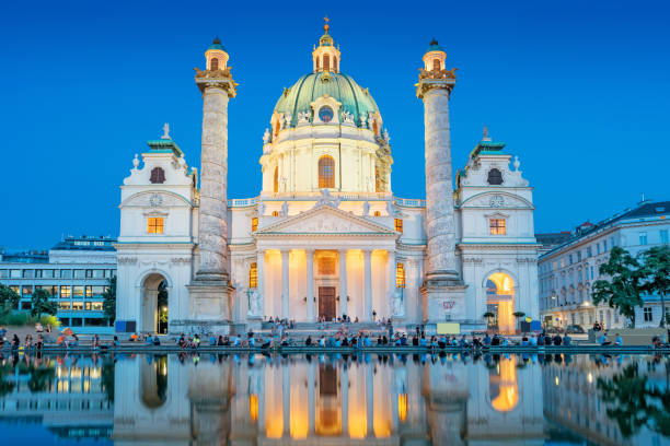Stock photograph of the landmark baroque style Karlskirche in Vienna Austria at twilight blue hour.