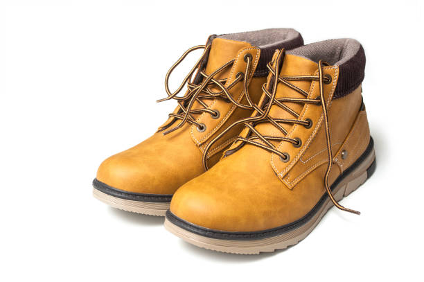 istock orange leather boots for men on white background 1186153363