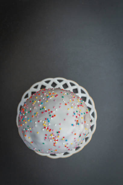 istock Easter spring cake in white glaze with colored sprinkles 1186153408