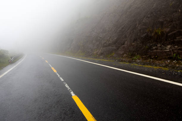 istock foggy road with yellow markings 1186153446