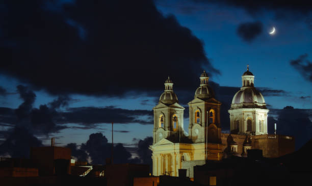 istock Spooky night time scene with a cloudy sky and moon and church 1186155124