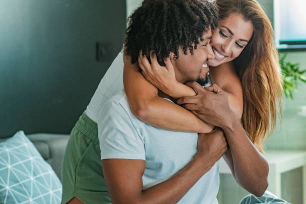 istock Young couple at home in bed smiling 1186157118
