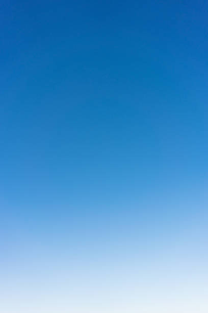 Clear graduated sky background A photograph of clear sky, darker blue at the top and lighter towards the horizon. light blue photos stock pictures, royalty-free photos & images