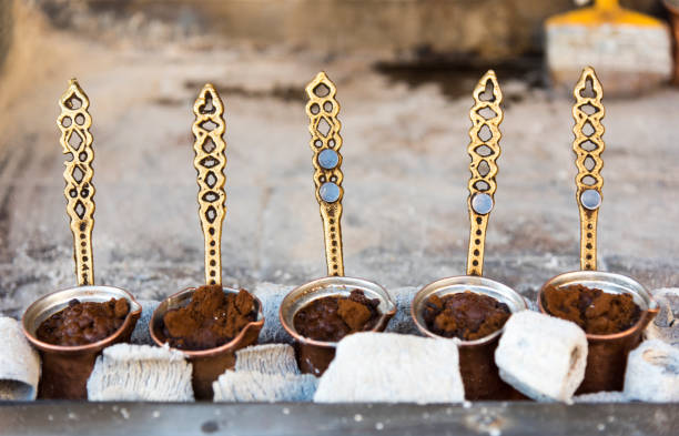 istock Traditional Turkish coffee cooked in hot sand and three copper cezve 1186159467