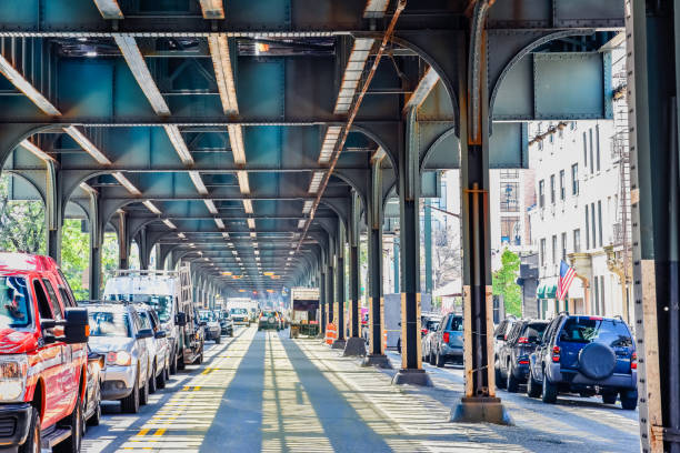 Bottom view of Elevated train track nyc. Traffic waiting in road in a sunny day. Travel and traffic concepts. Bronx, NYC, USA Bottom view of Elevated train track nyc. Traffic waiting in road in a sunny day. Travel and traffic concepts. Bronx, NYC, USA. railroad station platform photos stock pictures, royalty-free photos & images