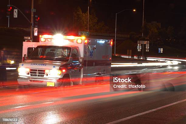 Ambulance In Traffic Stock Photo - Download Image Now - Ambulance, Lighting Equipment, Street Light