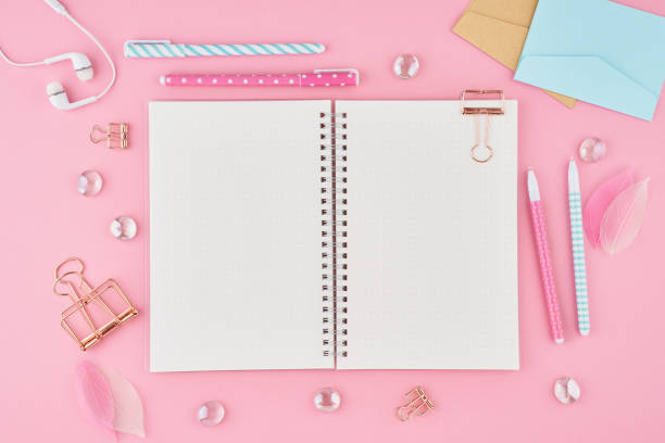 istock Blank notepad page in bullet journal on bright pink office desktop. Top view of modern bright table with notebook, stationery. Mock up, copy space, concept for diary 1186162147
