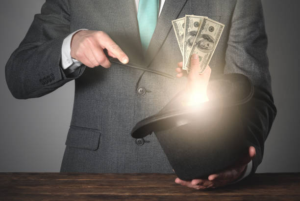 Money. Magician is casting a magic spell and get money from his bowler hat. magician money stock pictures, royalty-free photos & images