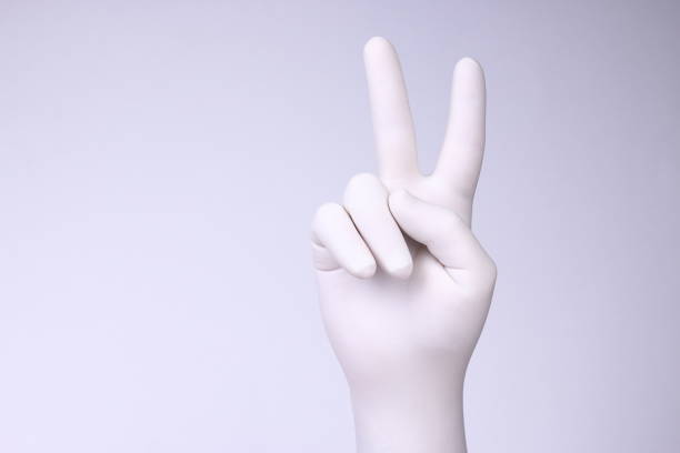 istock Hand with white glove showing victory sign 1186163280