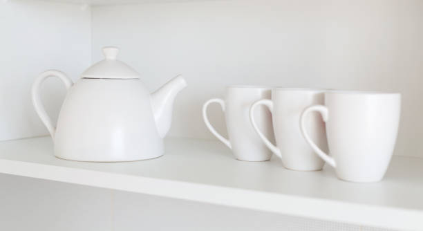 istock teapot and cups on the shelf 1186166645