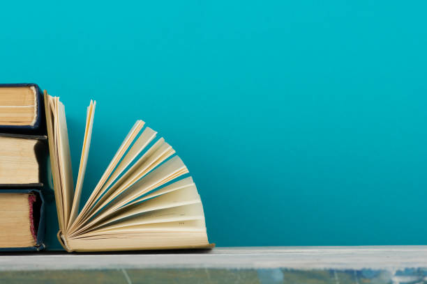 istock Open book, hardback books on wooden table. Back to school. Copy space 1186168924