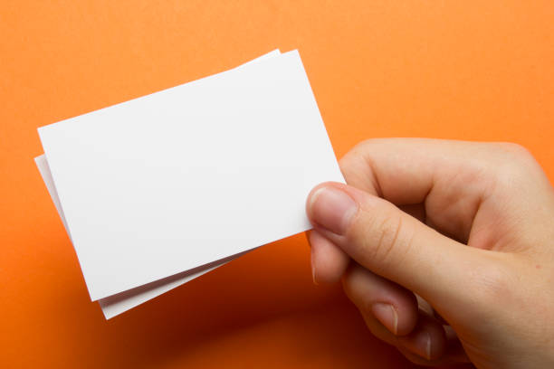 istock Hand holding white business card on white background 1186168940
