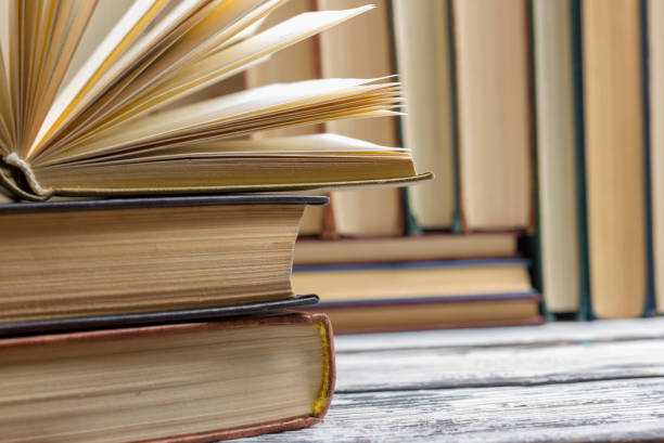 istock Open book, hardback books on wooden table. Back to school. Copy space 1186169347