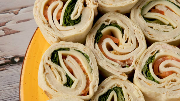 istock Sliced Turkey meat and cheese wrap sandwich 1186169451