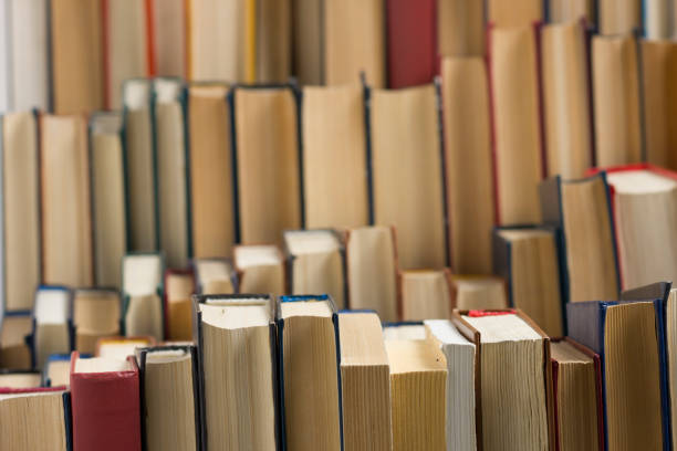 istock Open book, hardback books on wooden table. Back to school. Copy space 1186169482