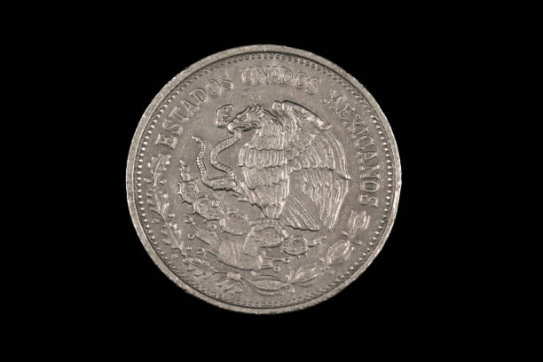 istock An old 500 Mexican peso coin isolated on a black background 1186169523