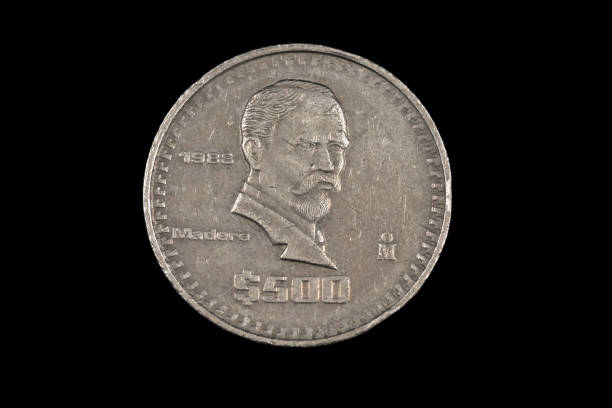 istock An old 500 Mexican peso coin isolated on a black background 1186169584