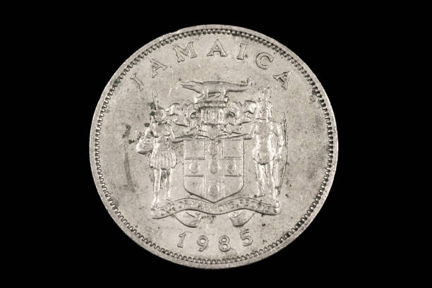 istock An old Jamaican coin isolated on a black background 1186170372