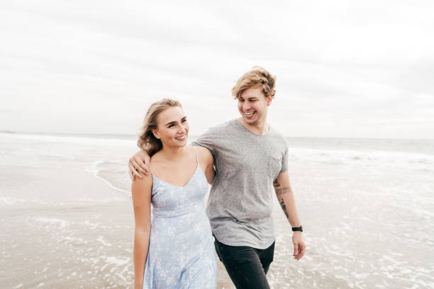 istock Couple walking on the beach 1186170462