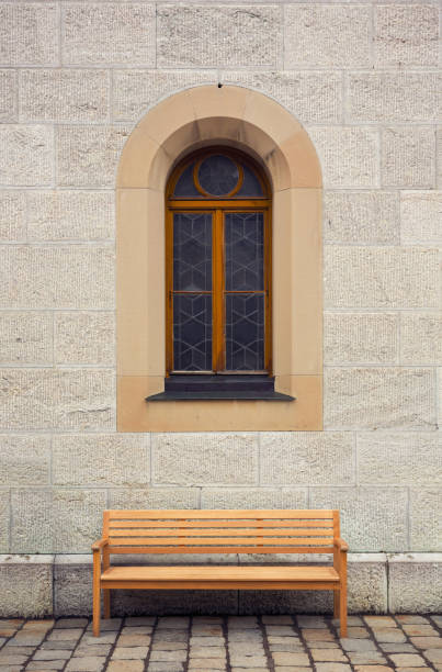 istock bench in from of old building with window 1186170537