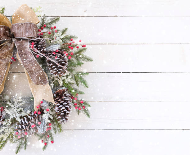 istock Christmas Wreath on an old White Wood Background 1186170582