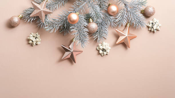 istock Christmas tree branch with luxury cream color decorations on copper background. Flat lay, top view, copy space. Xmas frame, winter holidays banner mockup, New Year greeting card 1186171550