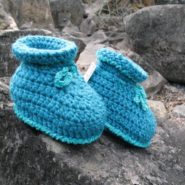 istock baby slippers in blue, handmade, crocheted, self-designed unique piece 1186173938