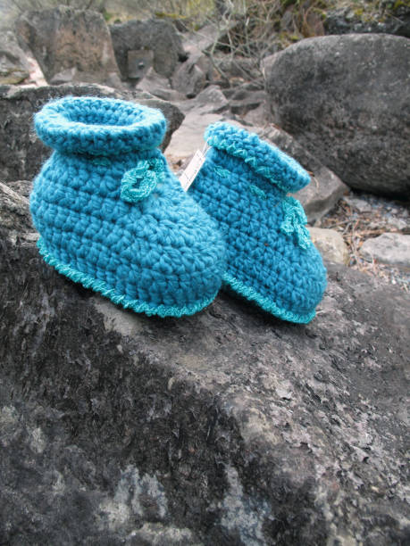 istock baby slippers in blue, handmade, crocheted, self-designed unique piece 1186173939