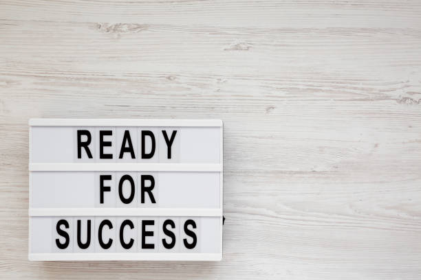 istock 'Ready for success' words on a lightbox on a white wooden surface, top view. Overhead, from above, flat lay. Copy space. 1186175133