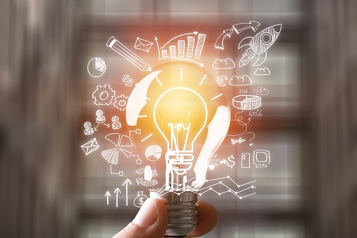 Hand holding the light bulb and business illustration