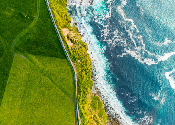 World famous Cliffs of Moher, one of the most popular tourist destinations in Ireland. Aerial view of known tourist attraction on Wild Atlantic Way in County Clare. World famous Cliffs of Moher, one of the most popular tourist destinations in Ireland. Aerial view of widely known tourist attraction on Wild Atlantic Way in County Clare. county clare stock pictures, royalty-free photos & images