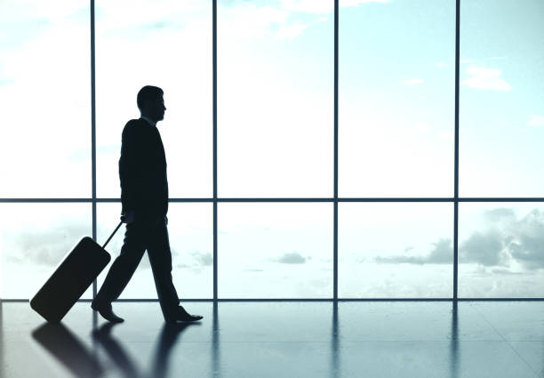 istock Businessman walking at airport 1186180627