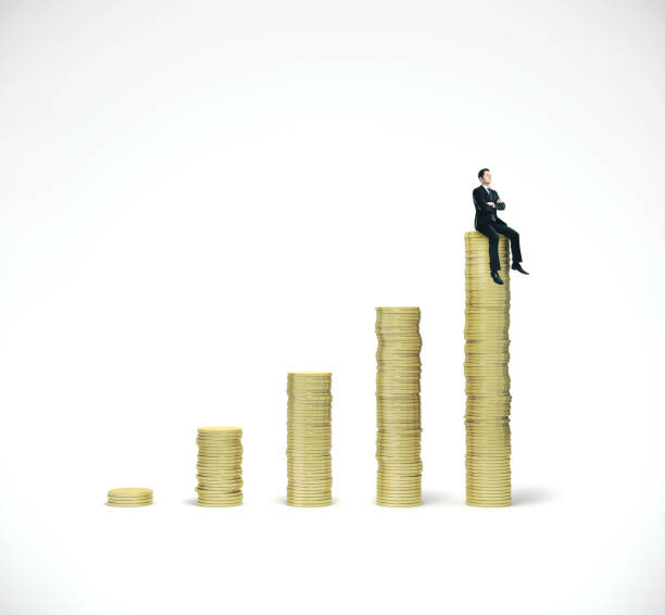istock Businessman sitting on gold coins chart 1186180763