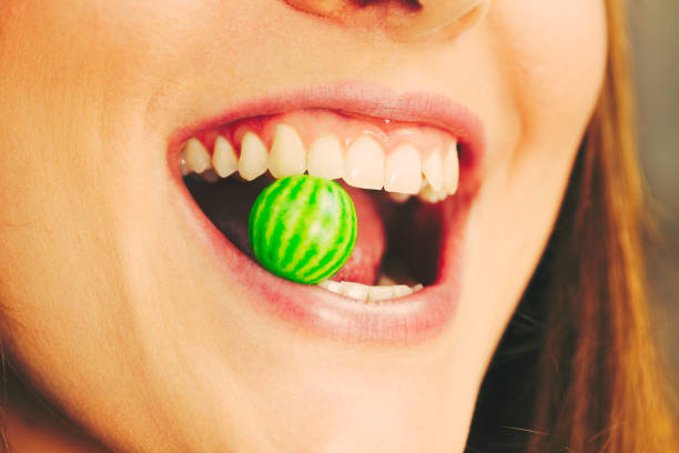Funky people concept. Attractive girl chewing gum. Young woman has beautiful smile and white teeth.