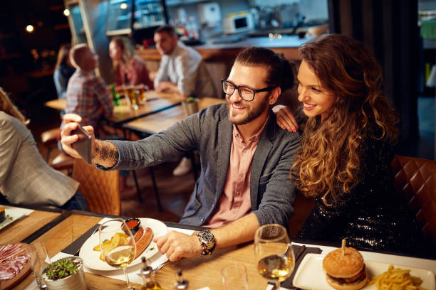 istock Couple taking selfie in restaurant. 1186181965