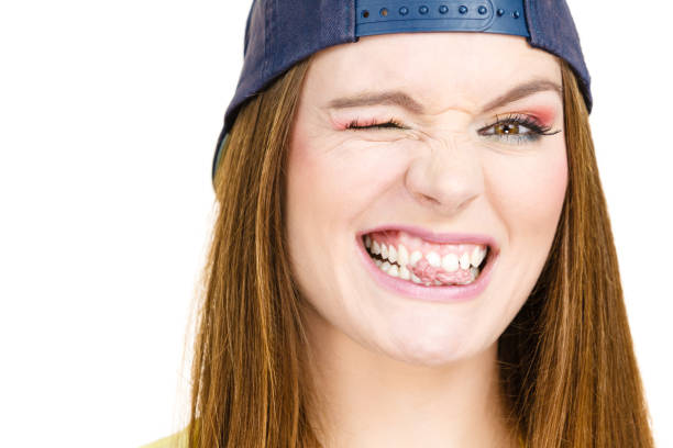 Funky people concept. Attractive girl chewing gum. Young woman has beautiful colourful make up.