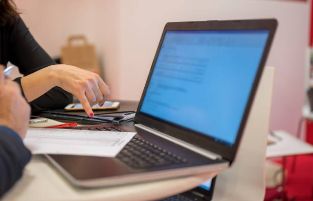 Midsection of business people working on laptop, Nikon Z7