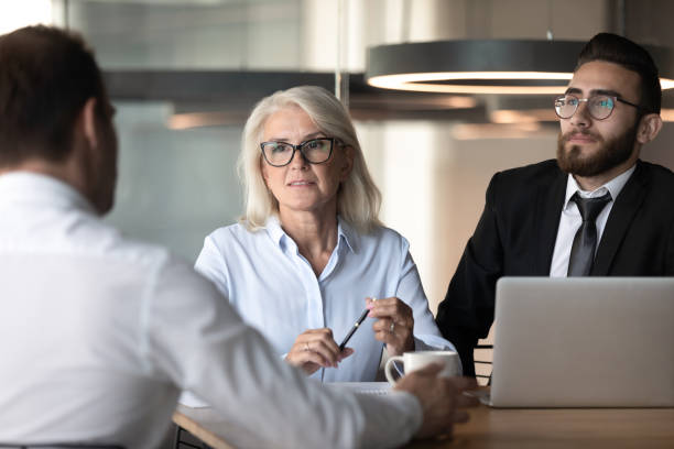 istock Diverse company representatives negotiating with corporate client at group meeting 1186185188