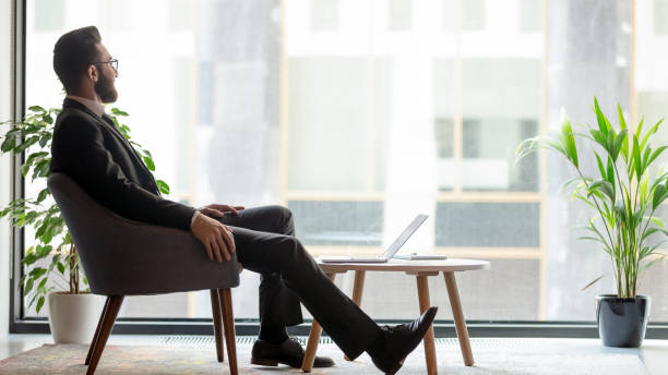 Horizontal banner middle eastern ethnicity businessman resting looking out window