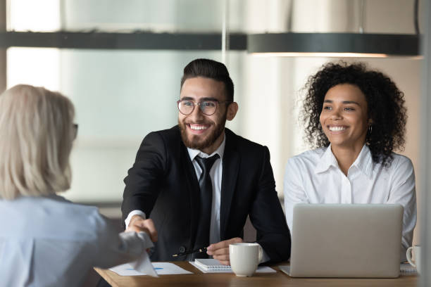 istock Happy arabian boss handshake greet client at group meeting indoors 1186185222